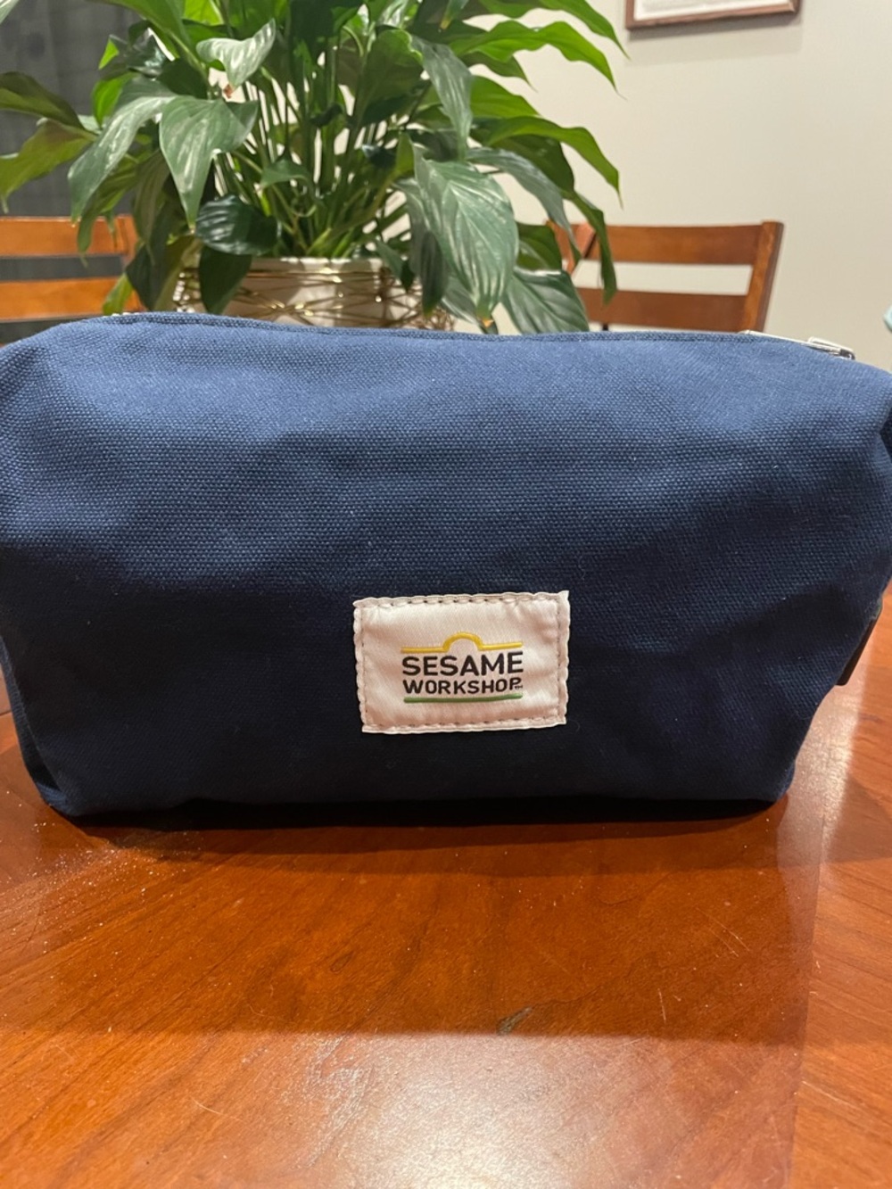 Steele Canvas Dopp Kit. Sesame Workshop logo. Navy blue waxed canvas.Made in USA